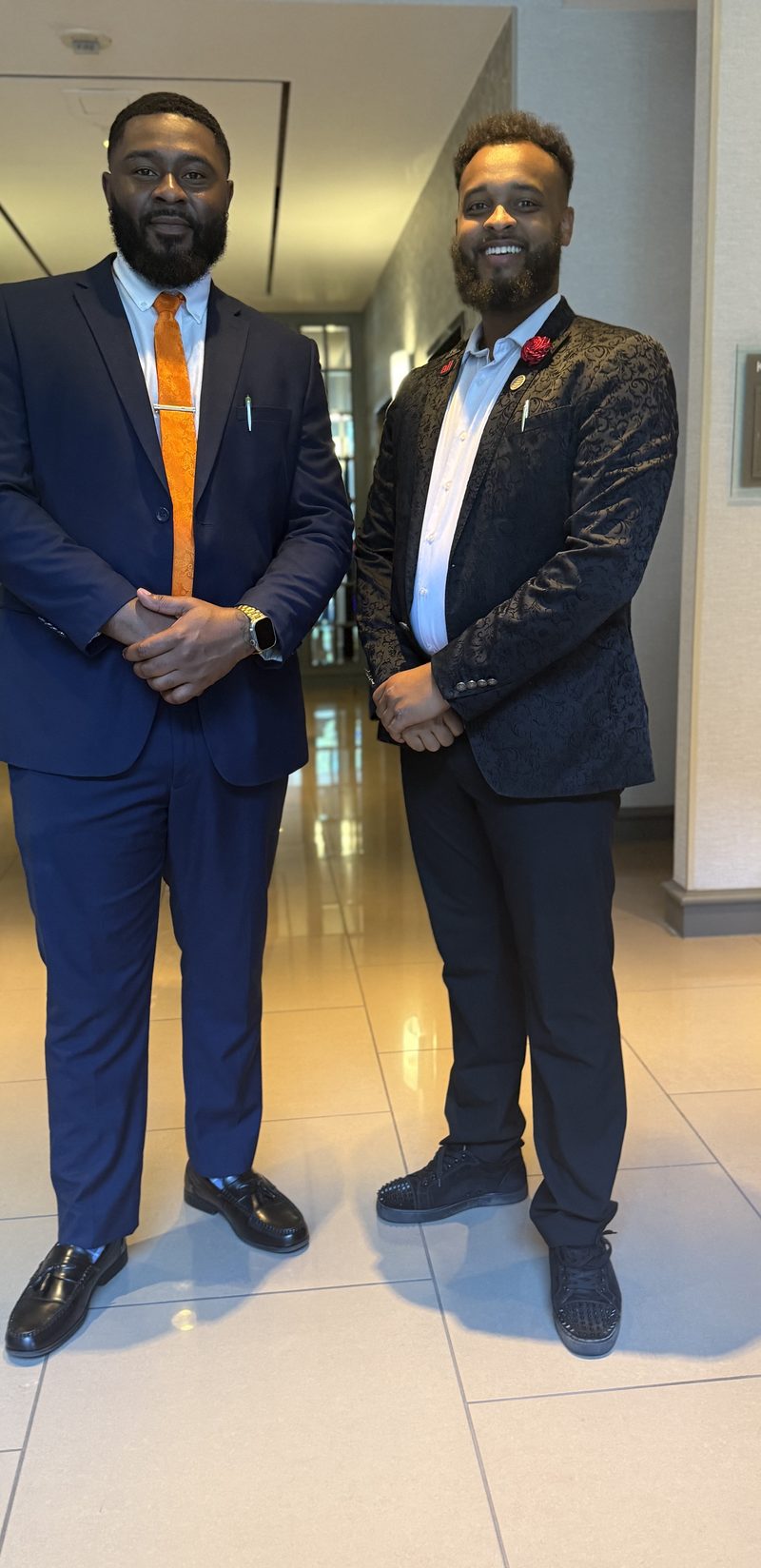 Two Onias Marketing leaders in suits before a conference session
