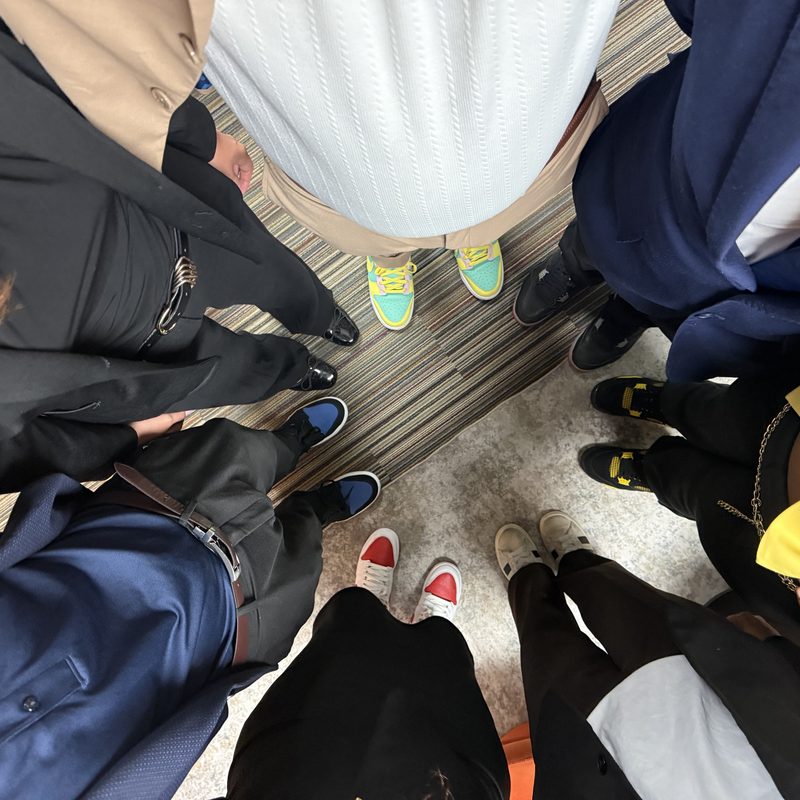 Overhead view of the Onias Marketing team huddled in a circle before the day begins