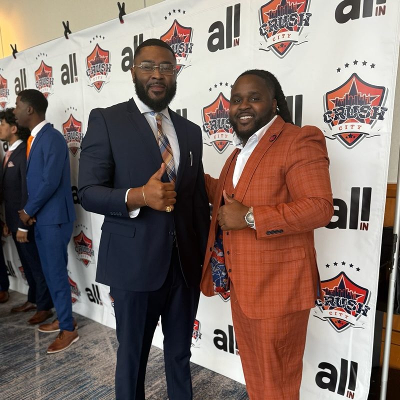 Tj Cromer, owner of Onias Marketing, with a team leader at a brand event